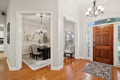 a view of a livingroom with furniture window and wooden floor
