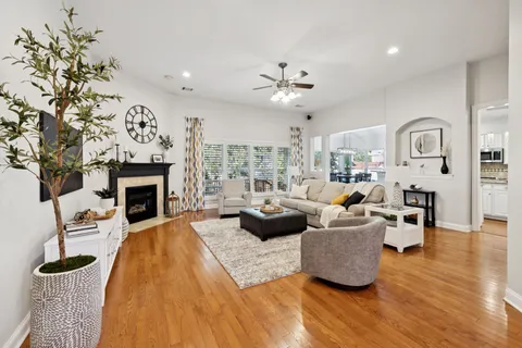 a living room with fireplace furniture and a fireplace