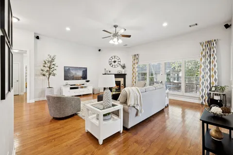 a living room with furniture fireplace and flat screen tv