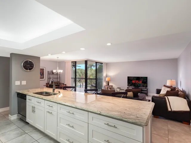 a kitchen with sink and mirror