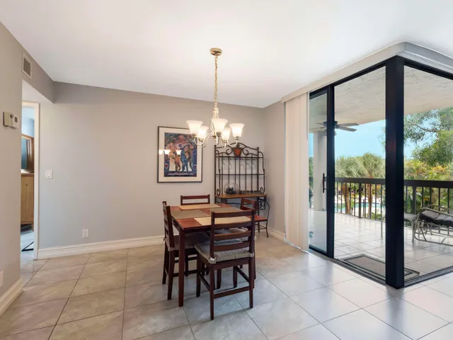 a view of a dining room with furniture wooden floor and a chandelier