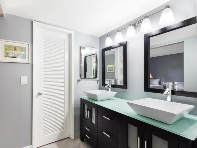 a bathroom with a double vanity sink and a mirror