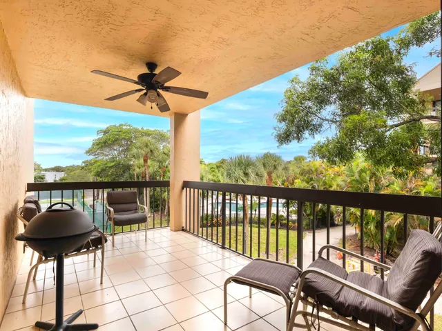 a view of a chairs and table in the balcony
