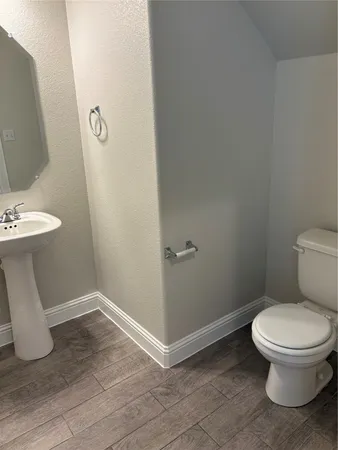 a white toilet sitting next to a bathroom sink