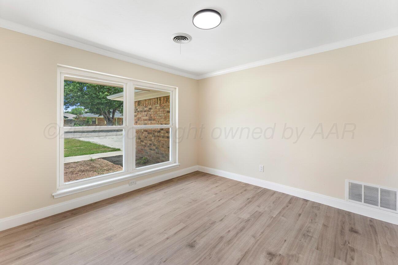 7204 Southwest 39th Avenue Amarillo, TX 79109 - Photo 7 of 51 an empty room with wooden floor and windows