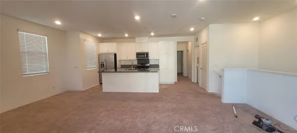 a kitchen with a refrigerator and a sink