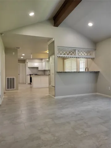 an empty room with a kitchen and a sink