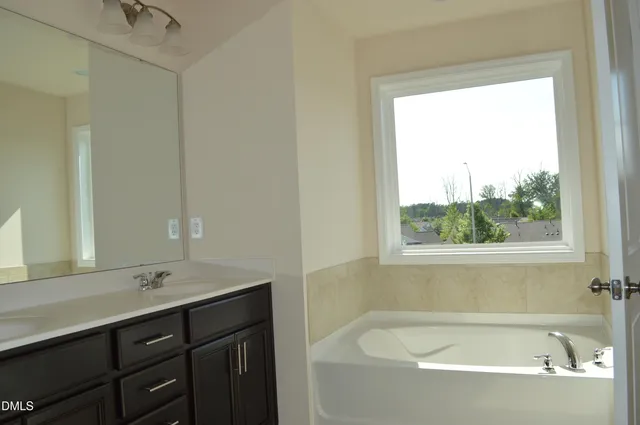 a white bath tub sitting next to a white sink