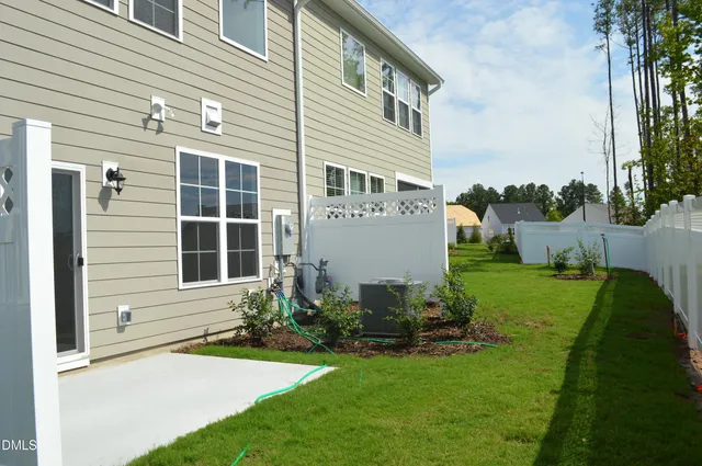 a front view of a house with a garden and plants