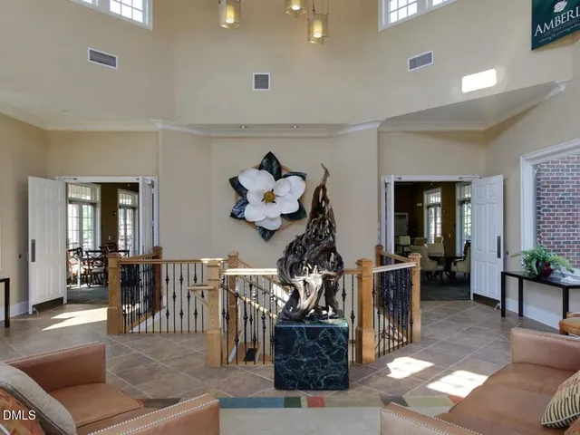 a living room with furniture a dining table and a potted plant