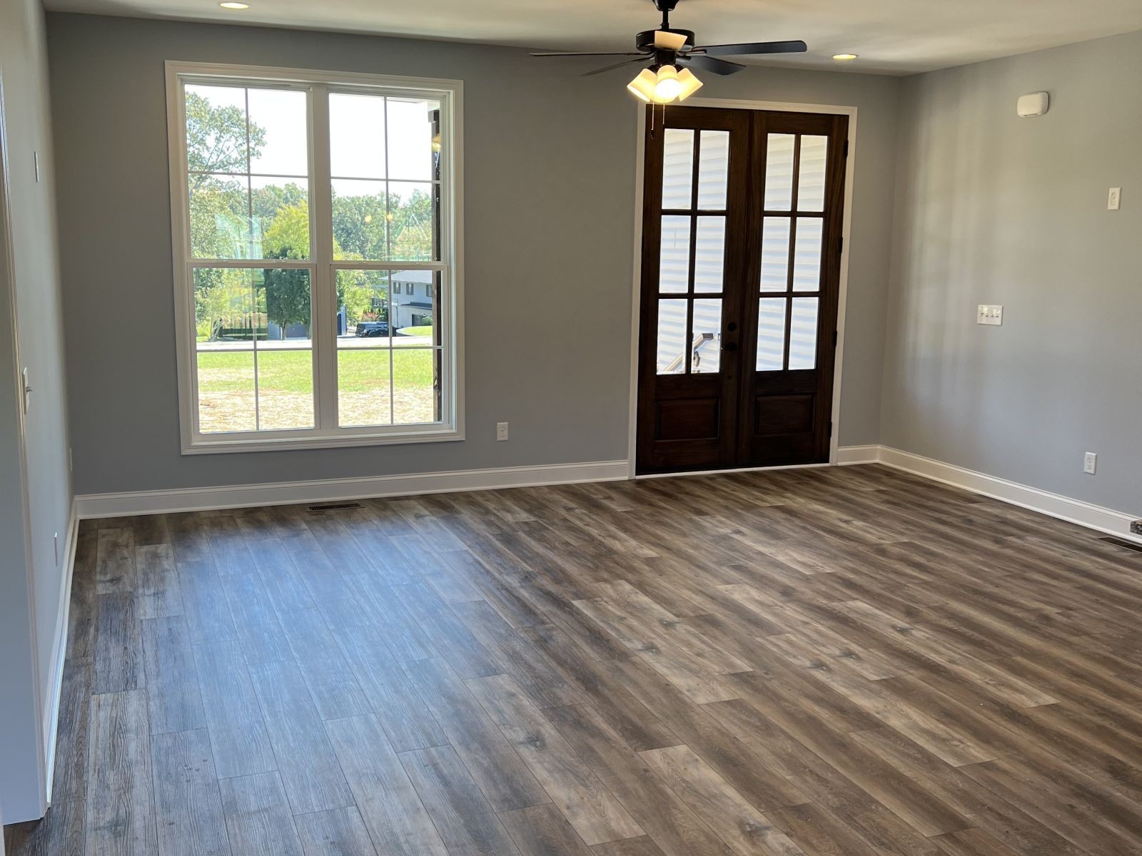 158 Faith-Rae Boulevard Morrison, TN 37357 - Photo 3 of 10 an empty room with wooden floor and windows