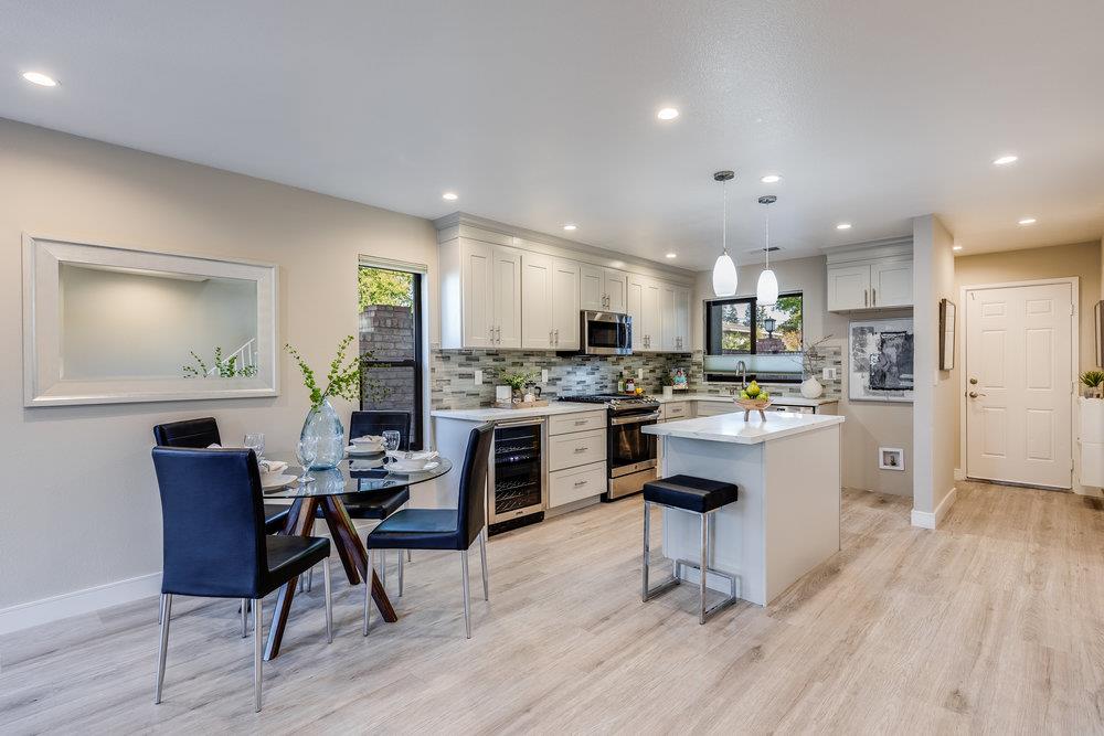 800 Rue Montagne Campbell, CA 95008 - Photo 11 of 53 a kitchen with a refrigerator a stove top oven and cabinets