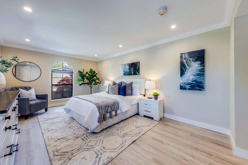 800 Rue Montagne Campbell, CA 95008 - Photo 22 of 53 a spacious bedroom with a large bed and a chandelier