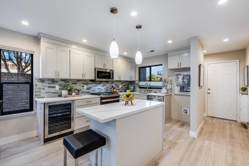 800 Rue Montagne Campbell, CA 95008 - Photo 5 of 53 a kitchen with white cabinets and stainless steel appliances