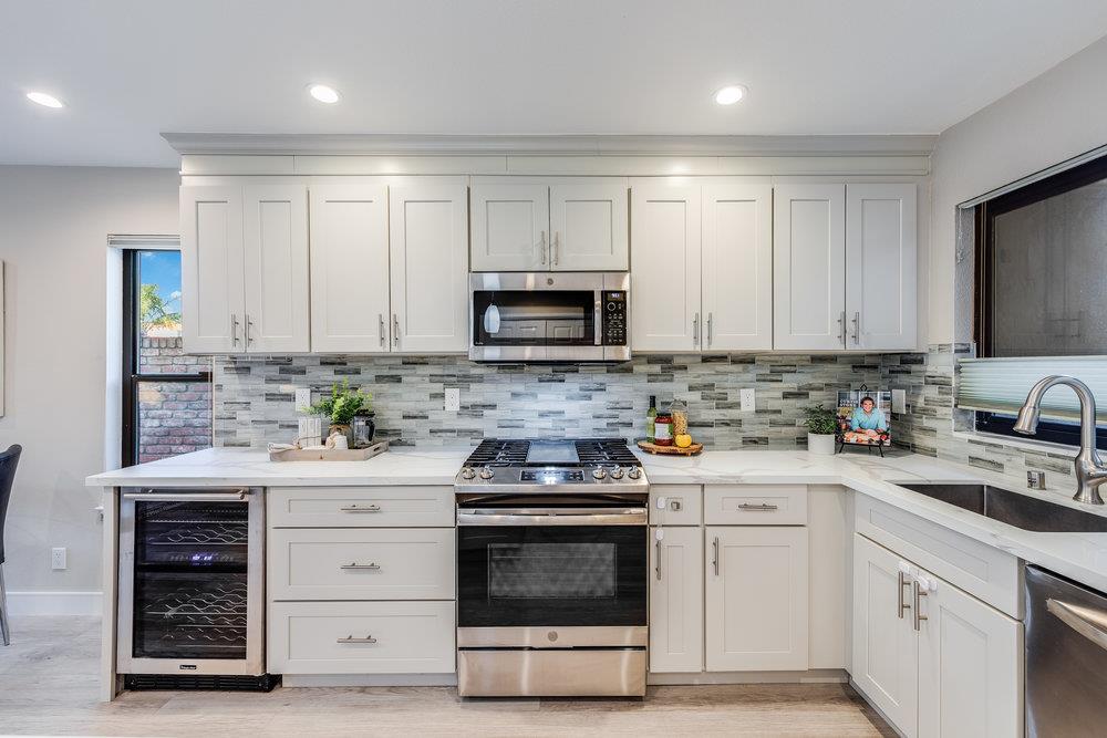 800 Rue Montagne Campbell, CA 95008 - Photo 8 of 53 a kitchen with granite countertop white cabinets and stainless steel appliances