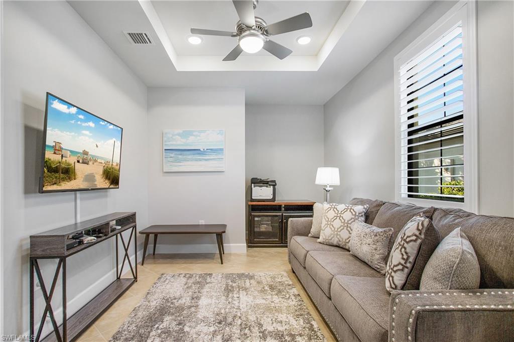 7674 Jacaranda Lane Naples, FL 34114 - Photo 16 of 45 a living room with furniture and a large window