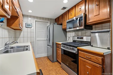 a kitchen with stainless steel appliances granite countertop a stove and a refrigerator