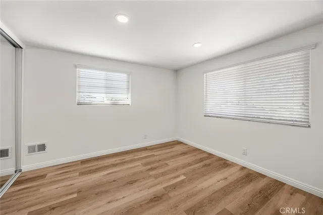 a view of a room with wooden floor and windows