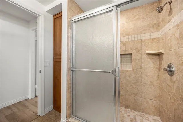 a bathroom with a glass shower door