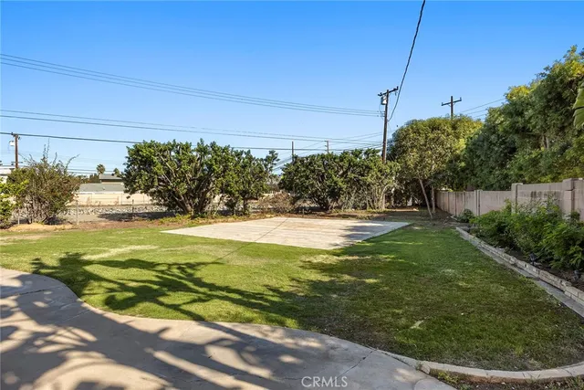 a view of yard with swimming pool and trees