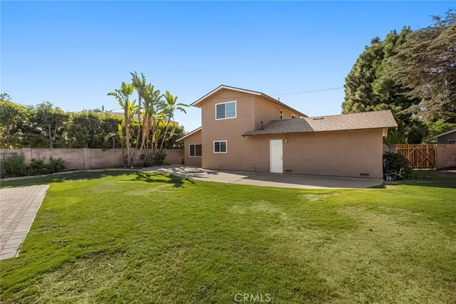 a house view with swimming pool in front of it