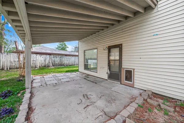 a view of a backyard with wooden fence