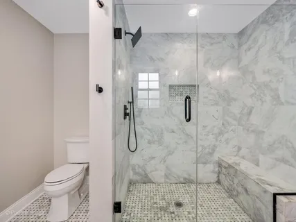 a bathroom with a shower toilet and sink