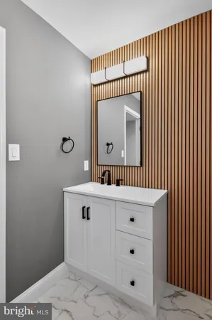 a bathroom with a sink a mirror and a vanity