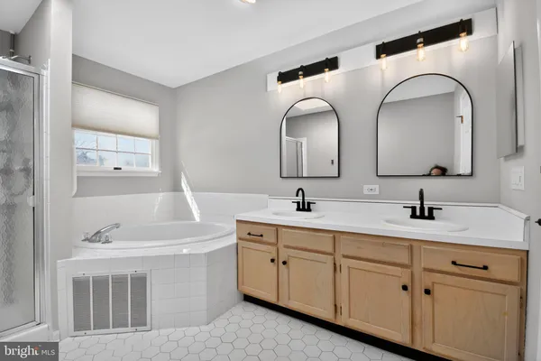 a bathroom with a tub and shower