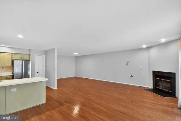 a view of a kitchen with wooden floor and a sink