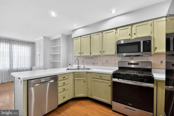 a kitchen with a sink stove and microwave