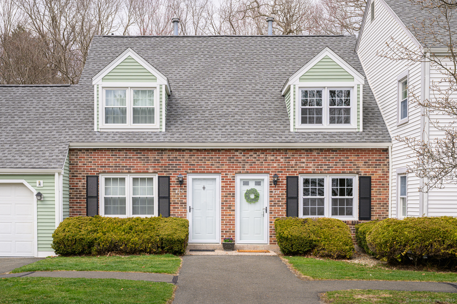474 Dowd Avenue, Unit 474 Canton, CT 06019 - Photo 1 of 1 a front view of a house with a yard and plants