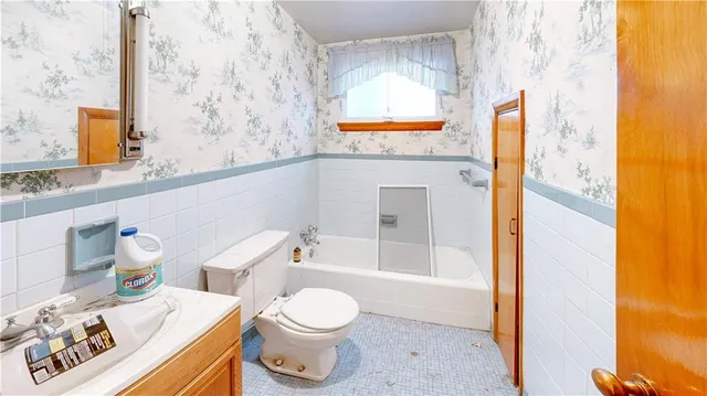a bathroom with a sink a toilet and bathtub