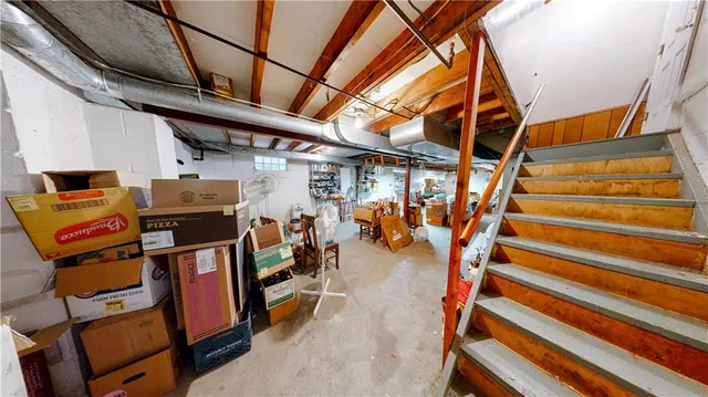 a view of a storage room with furniture and a window