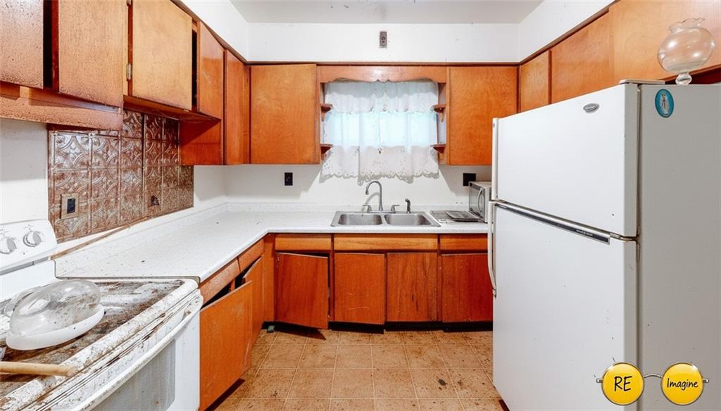 1022 Melrose Avenue Ambridge, PA 15003 - Photo 32 of 39 a kitchen with stainless steel appliances granite countertop a refrigerator and a sink