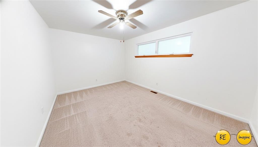 1022 Melrose Avenue Ambridge, PA 15003 - Photo 34 of 39 an empty room with a window and ceiling fan