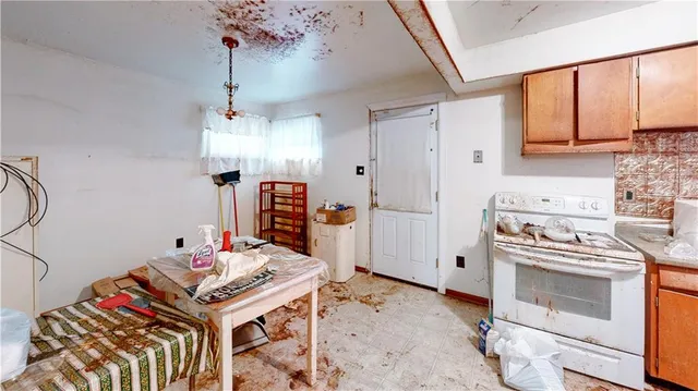 a kitchen that has a stove and a table