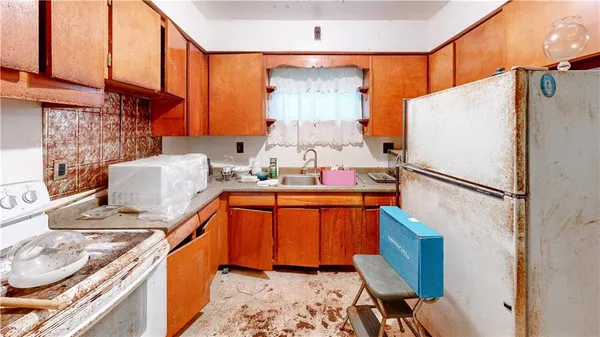 a kitchen with stainless steel appliances granite countertop a refrigerator and a stove