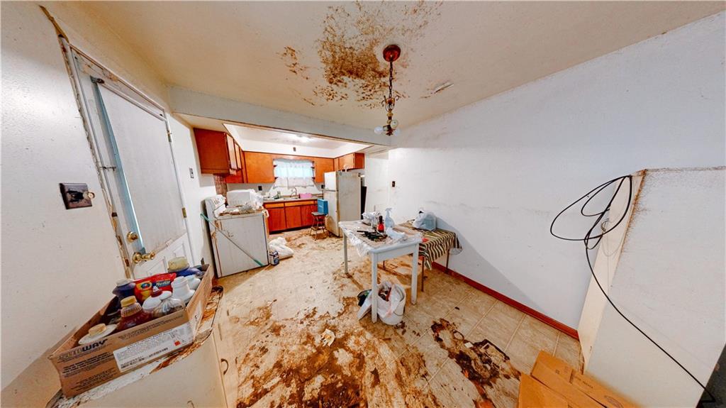 1022 Melrose Avenue Ambridge, PA 15003 - Photo 10 of 39 a bed room with a bed and a chandelier