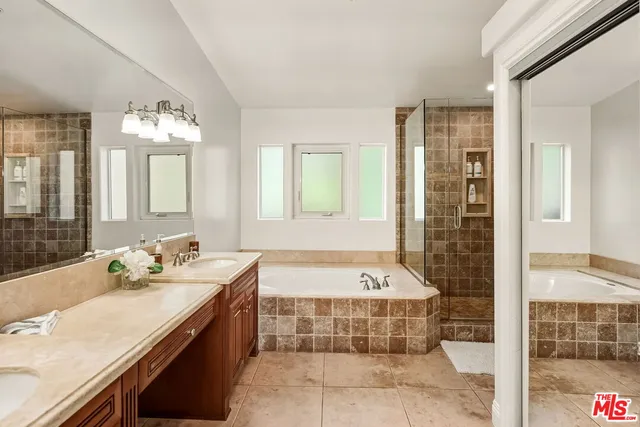 a bathroom with a tub sink and mirror