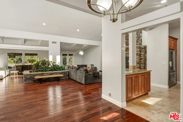 a view of a livingroom with furniture hardwood floor and a ceiling fan