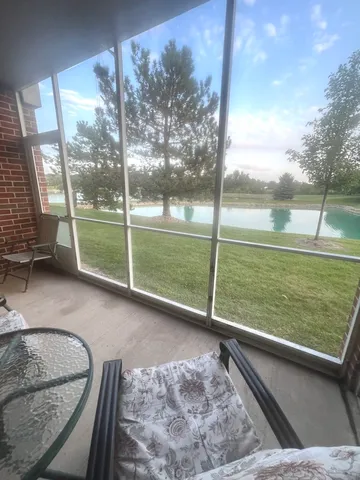 a view of a living room and a floor to ceiling window