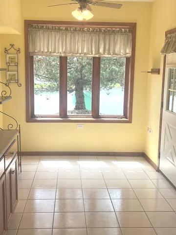 a view of a kitchen with an empty space and a window