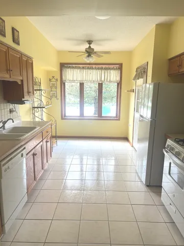 a large bathroom with a granite countertop sink a large mirror and a bathtub