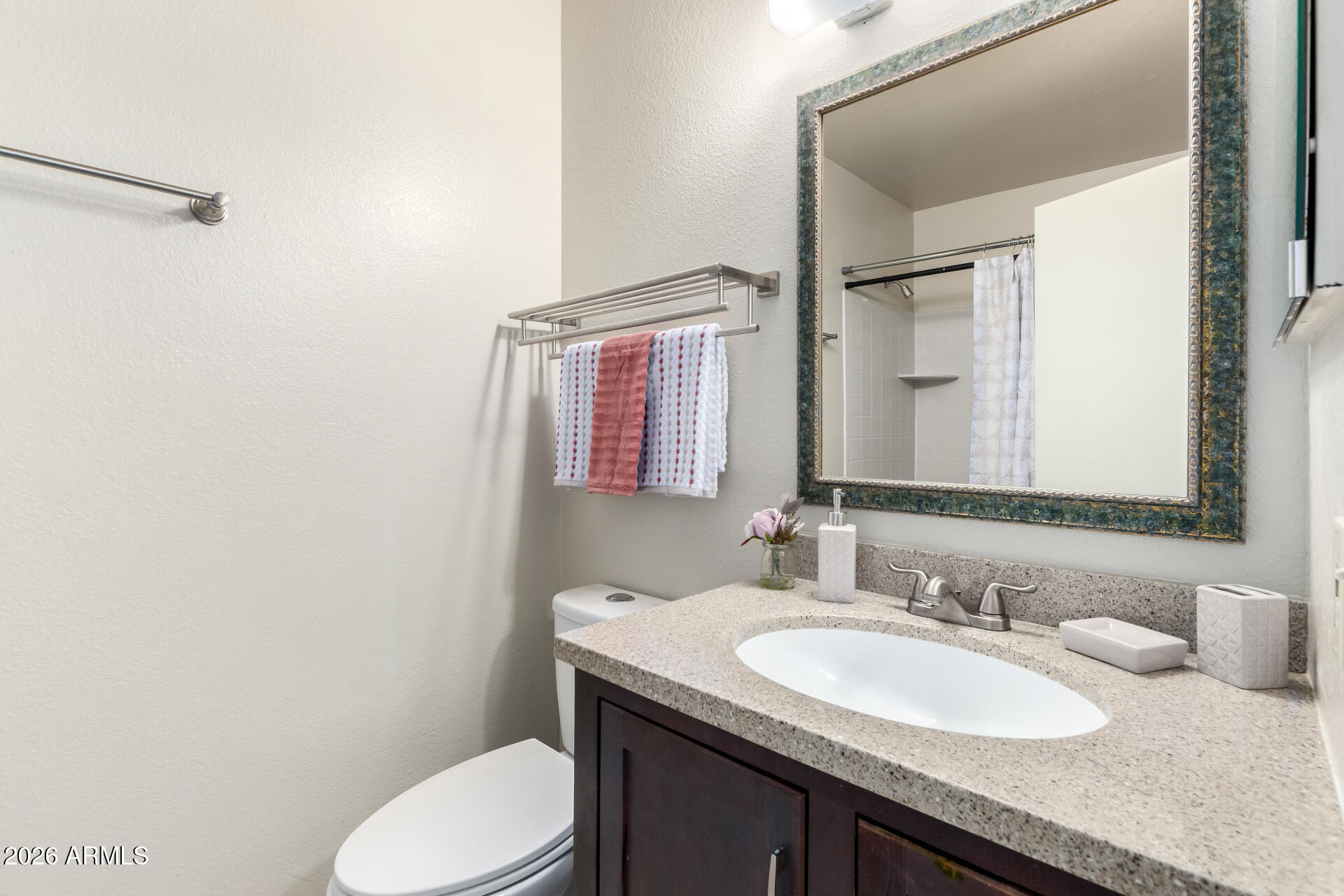 8111 West Wacker Road, Unit 13 Peoria, AZ 85381 - Photo 19 of 28 a bathroom with a granite countertop sink toilet and mirror