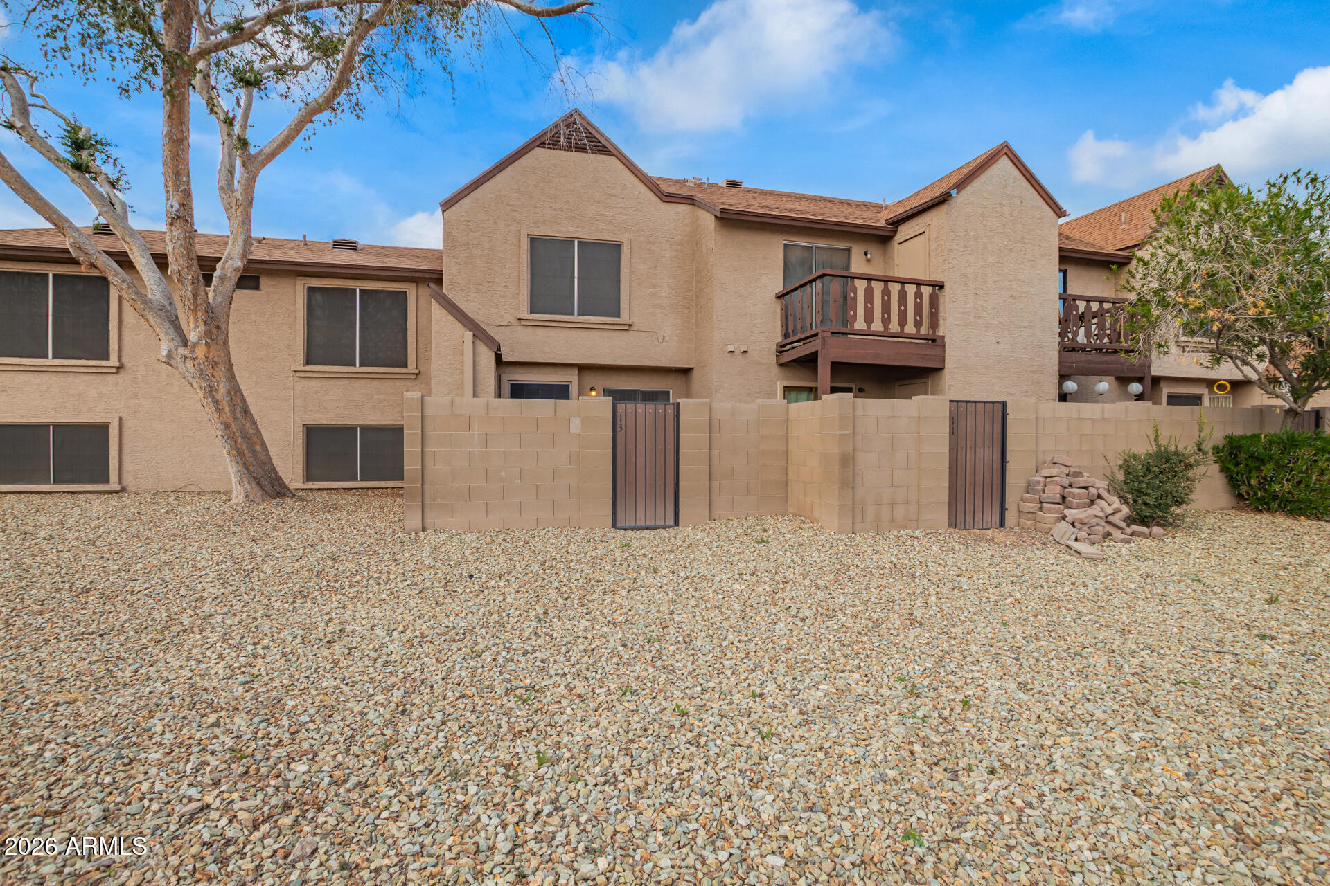 8111 West Wacker Road, Unit 13 Peoria, AZ 85381 - Photo 23 of 28 a front view of a house with a yard