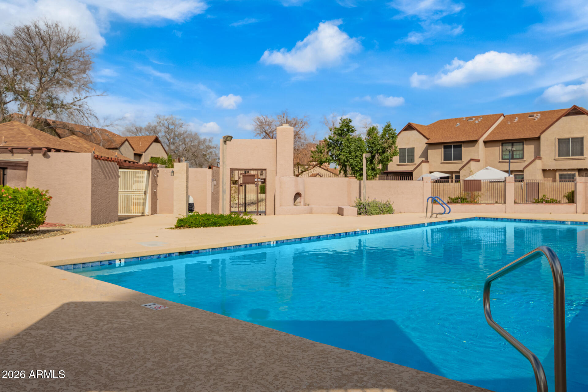 8111 West Wacker Road, Unit 13 Peoria, AZ 85381 - Photo 25 of 28 a view of a swimming pool with an outdoor seating
