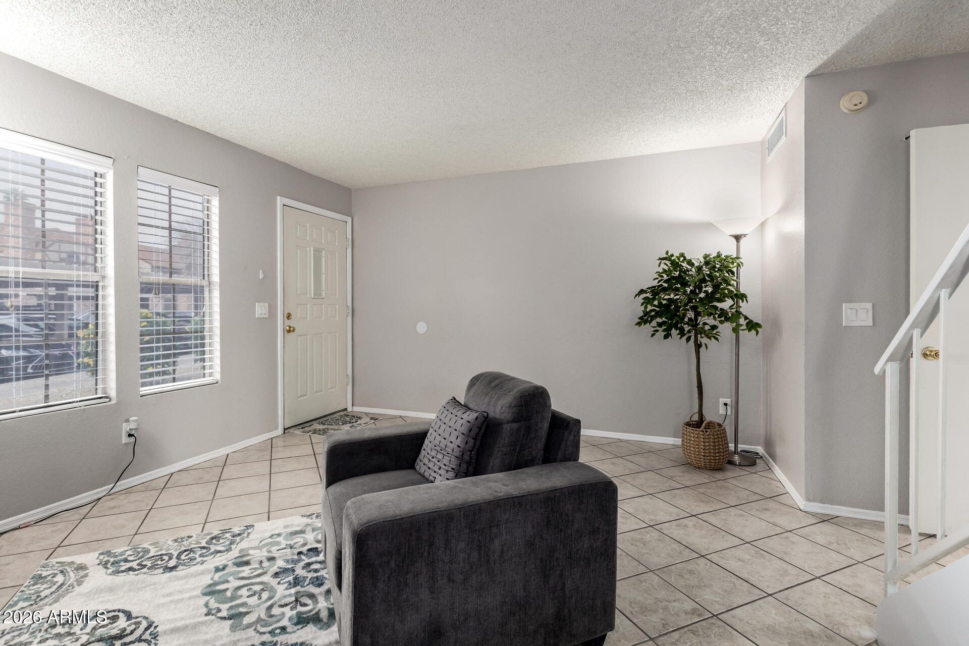 8111 West Wacker Road, Unit 13 Peoria, AZ 85381 - Photo 4 of 28 a living room with furniture and a potted plant
