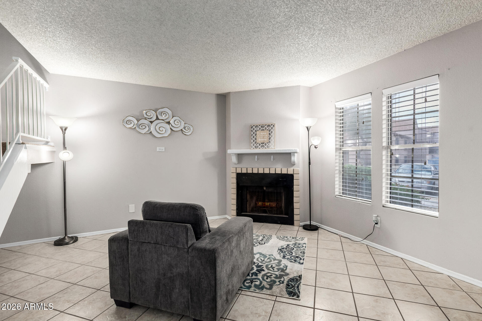 8111 West Wacker Road, Unit 13 Peoria, AZ 85381 - Photo 5 of 28 a living room with furniture and a fireplace
