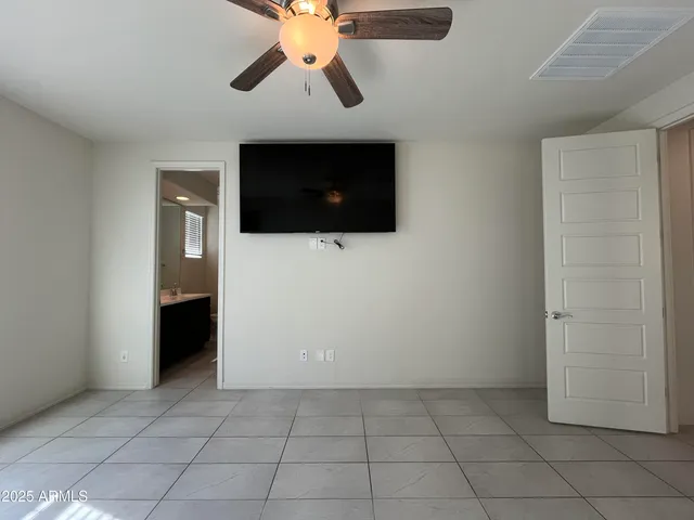a view of an empty room with window and cabinet